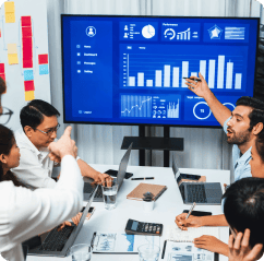 Team reviewing analytics charts on a large screen